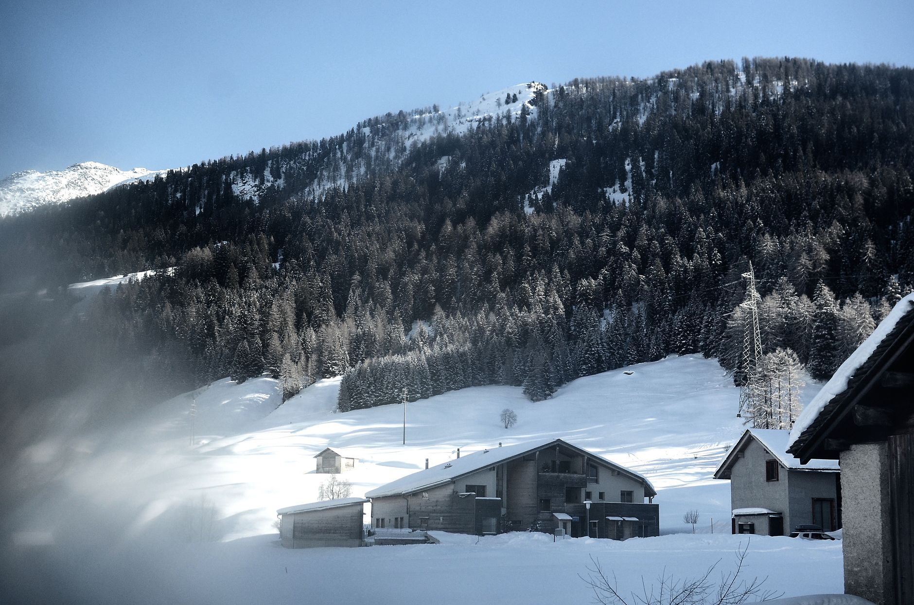 Alpine valley with minimalist wooden lodge